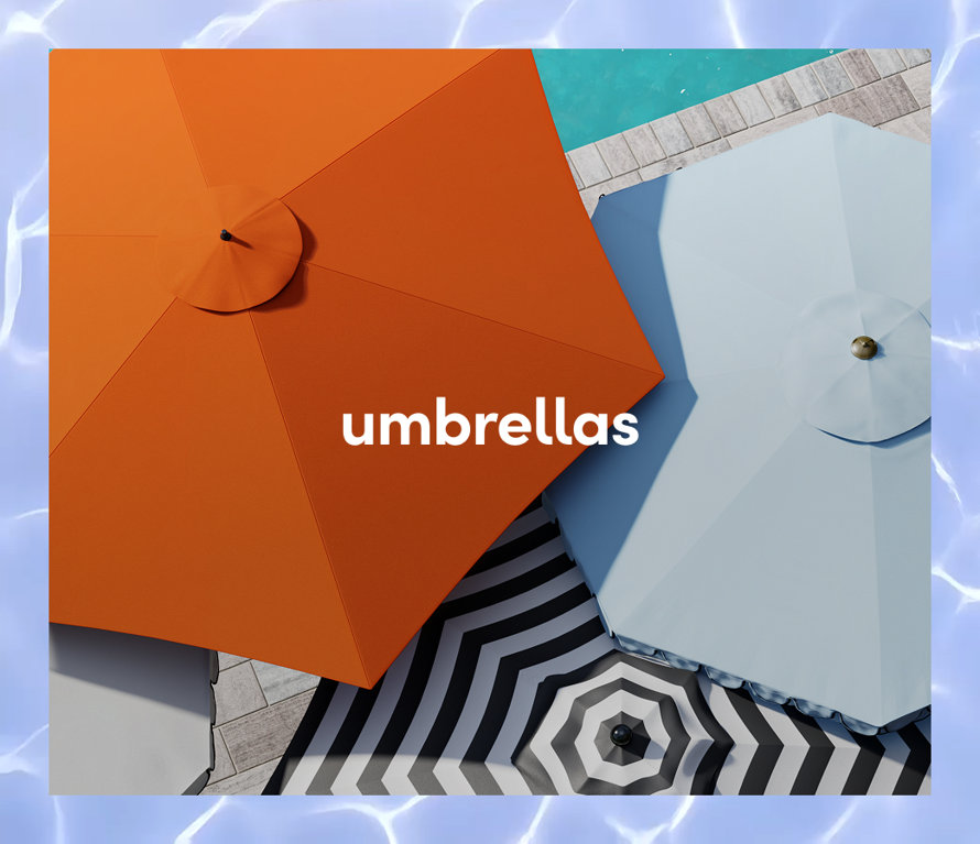 An overhead view of vibrant orange, light blue, and black-and-white striped outdoor patio umbrellas by a pool.