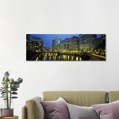 Low Angle View Of Buildings Lit Up At Night, Chicago River, Chicago, Illinois, USA by Panoramic Images - Wrapped Canvas Panoramic Print