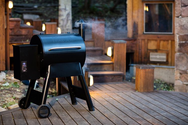 small black outdoor pellet grill on deck