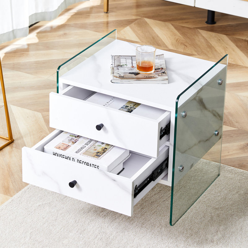 Double-Drawer Bedside Table. The Board Surface Is MDF With Wood Grain Sticker, And Both Sides Are Transparent Tempered Glass. The Design Is Simple And Elegant, With Excellent Storage Functions.