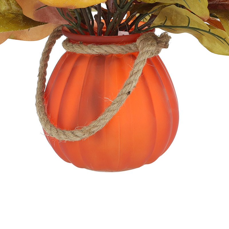 Fall Leaves Arranged in Glass Pumpkin Vase