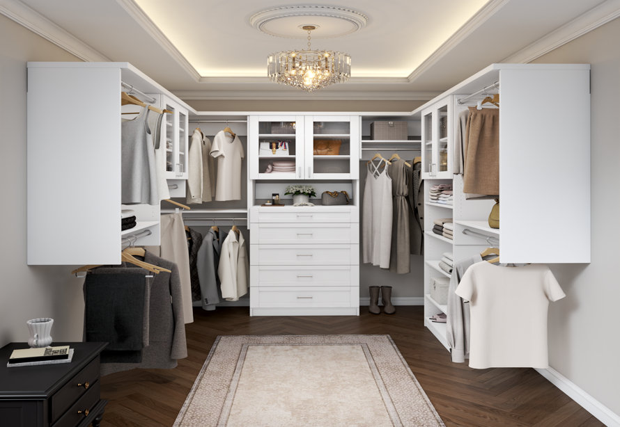 Walk-in closet with white modular shelving, hanging racks, and a central dresser under a crystal chandelier.