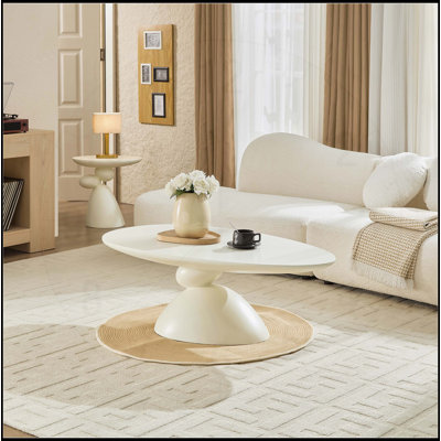 Table basse moderne et minimaliste ovale avec base sculpturale en pierre porte-bonheur