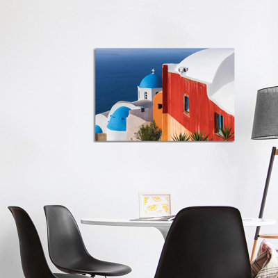 Greece, Santorini, Oia. Colourful House And Church. by Jaynes Gallery - Wrapped Canvas Print