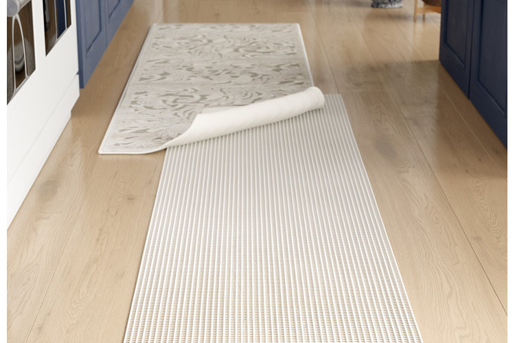 PVC padded runner rug pad on hardwood floors and paired with a white runner rug.