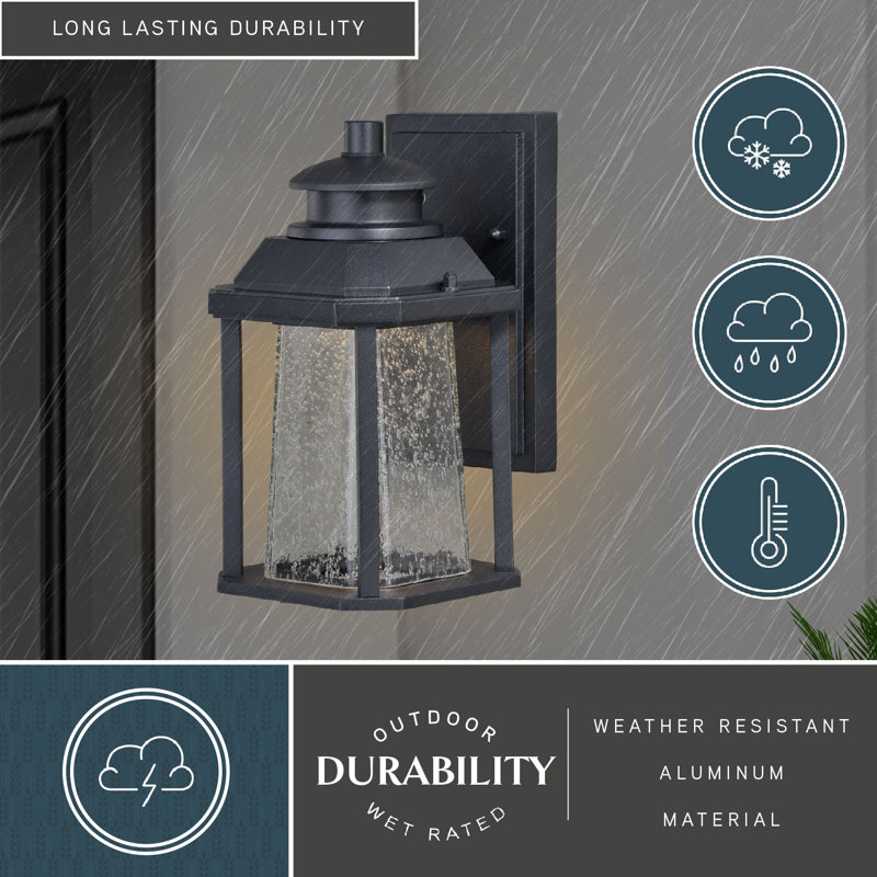 Farren 9.75 in. H 1-Light Textured Black Dusk to Dawn Sensor Outdoor Wall Sconce, Rust-Resistant Aluminum, Clear Seeded Glass Shade, Integrated LED for Porch Patio Front Door or Garage