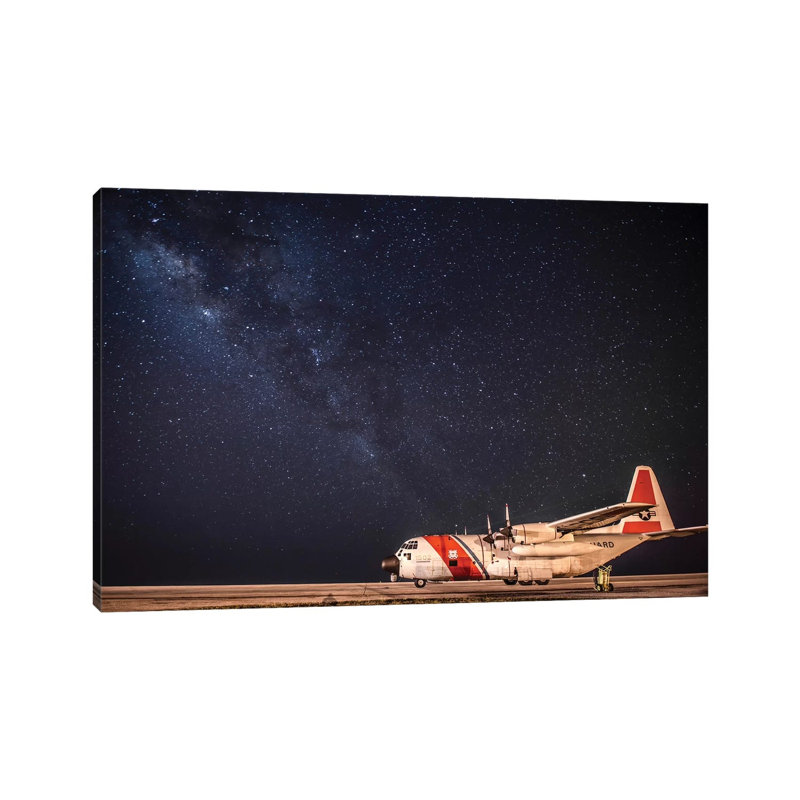 A US Coast Guard C-130 Hercules Parked On The Tarmac On A Starry Night by Stocktrek Images - Wrapped Canvas Print