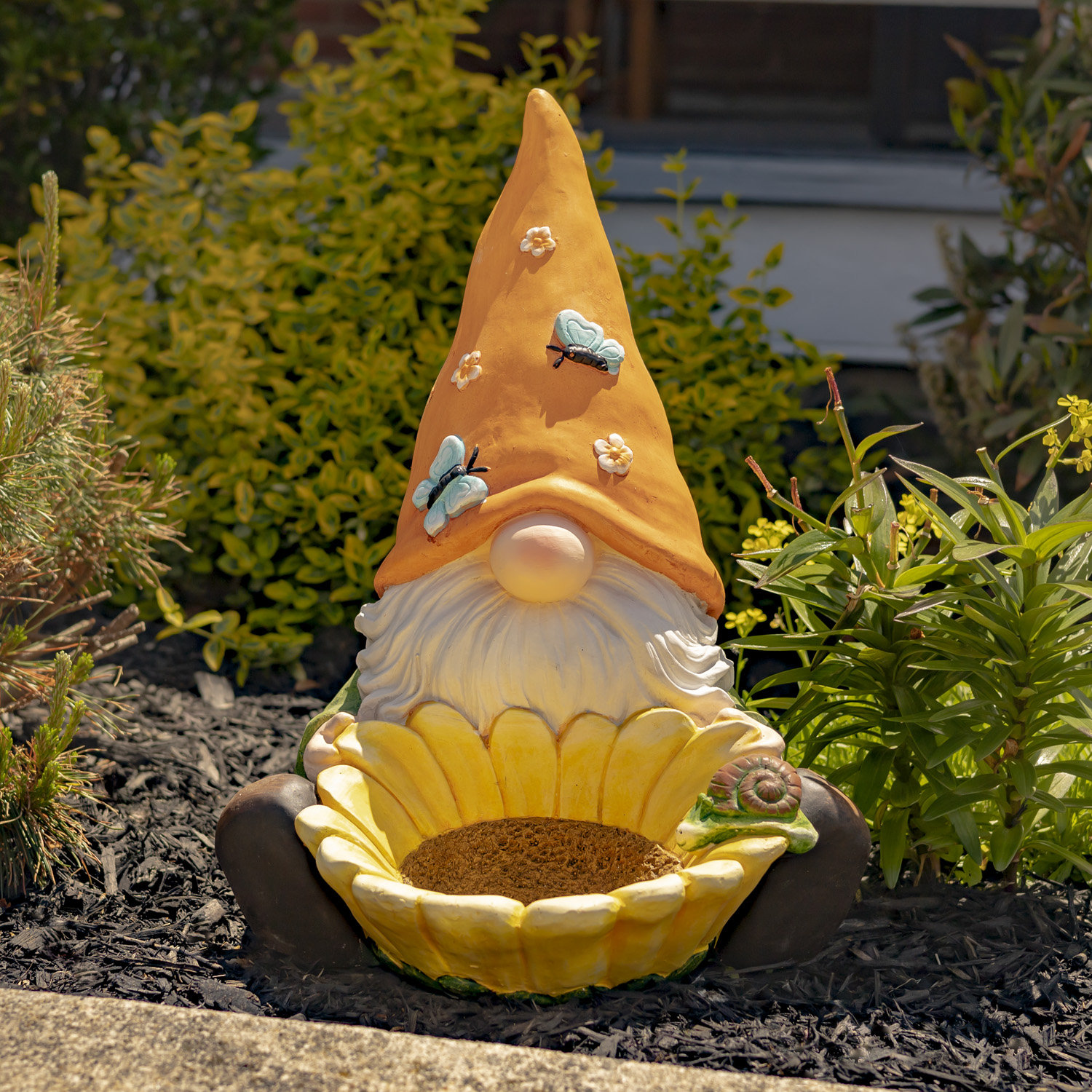 https://assets.wfcdn.com/im/01295563/compr-r85/2532/253233041/magnesium-garden-gnome-sitting-with-giant-flower-and-orange-hat-with-butterflies-the-smallfries.jpg