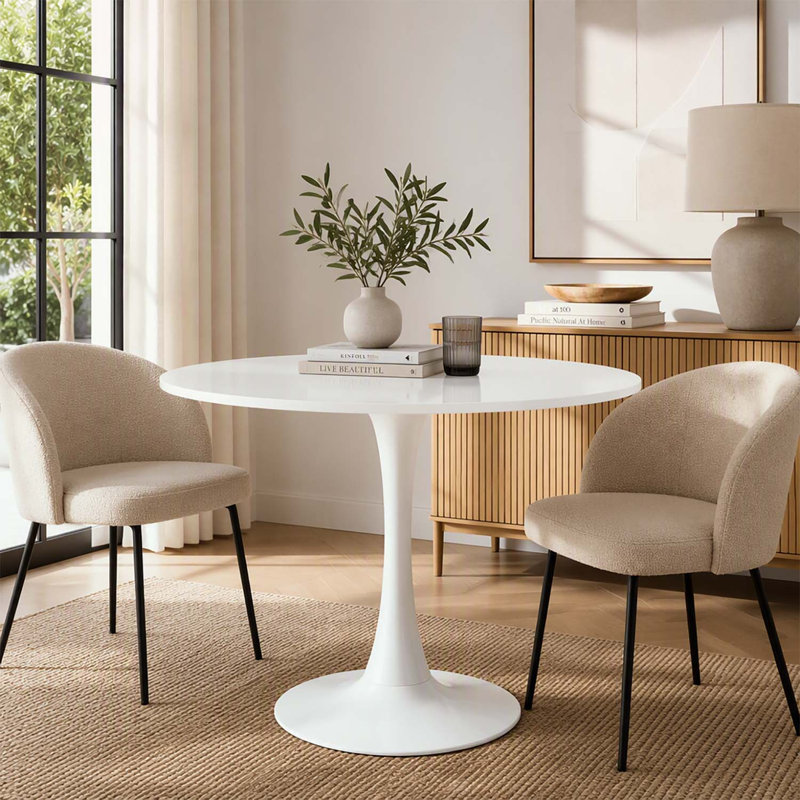 Table de salle à manger ronde blanche moderne avec un piètement robuste à une seule colonne, idéale pour les petits espaces de vie et les cuisines.