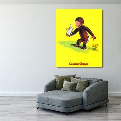 Curieux George tient un lapin