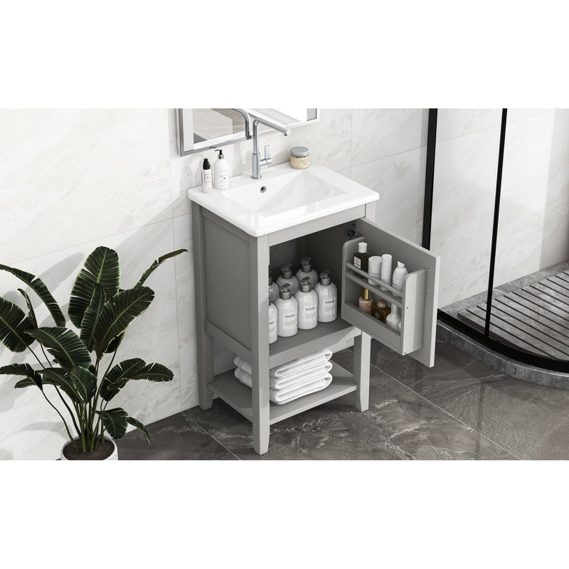 Meuble-lavabo gris avec lavabo de 50 cm, en bois massif, avec tablette de rangement et design pratique.