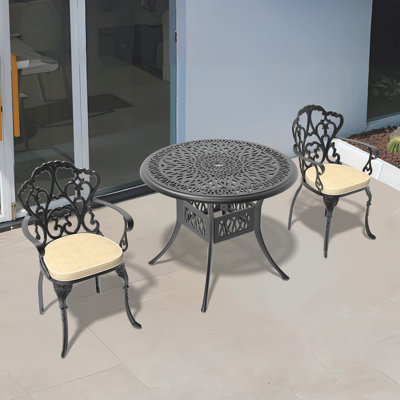  Ensemble repas de patio avec table ronde Akiesha, coussins rouges inclus