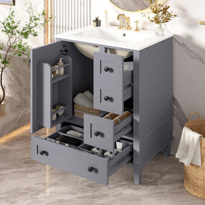 Meuble-lavabo de 24 pouces avec lavabo en céramique intégré, comprenant une tablette double couche montée sur la porte, des tiroirs à fermeture douce et une porte d'armoire à fermeture douce.