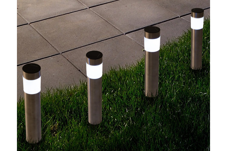 closeup of four bollard lights at night