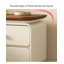 Table de chevet minimaliste de couleur crème, avec des tiroirs en bois massif et des rails coulissants silencieux, convient à une utilisation dans la chambre à coucher.