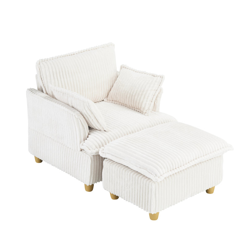 Ce canapé en velours côtelé à siège unique comprend un repose-pieds et des coussins décoratifs. Il est parfait pour s'asseoir ou s'allonger confortablement