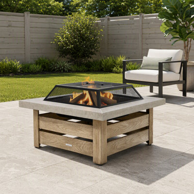 Foyer extérieur en acier de 86 cm (34 pouces) à bois, avec table et motif décoratif ajouré, idéal pour les feux de camp dans le jardin ou la terrasse.