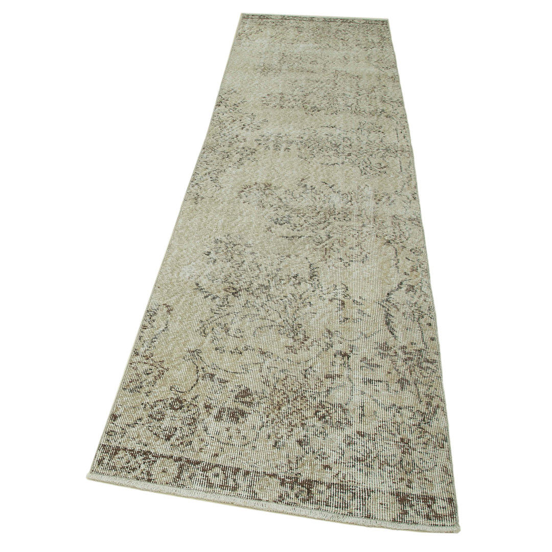 Handgefertigter Teppich Tuttle aus Wolle in Beige