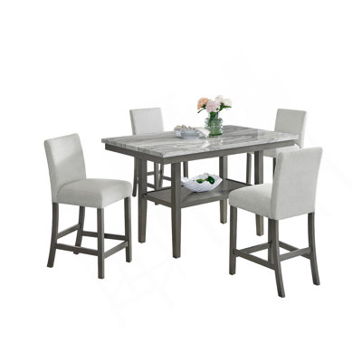 Selena 5-Piece 60" Rectangular Gray Faux Marble Counter Height Dining Set With Storage Shelf & Light Gray Upholstered Chairs by Latitude Run