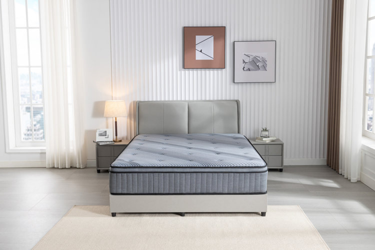 large gray mattress on a gray bed with tufted headboard in a large bedroom
