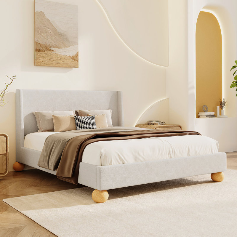 Lit plateforme tapissier moderne avec tête de lit à oreilles et pieds ronds en bois