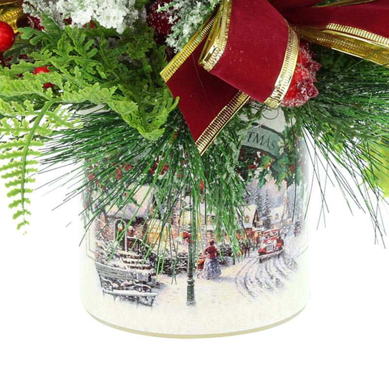 Festive holiday arrangement with greens and Berries