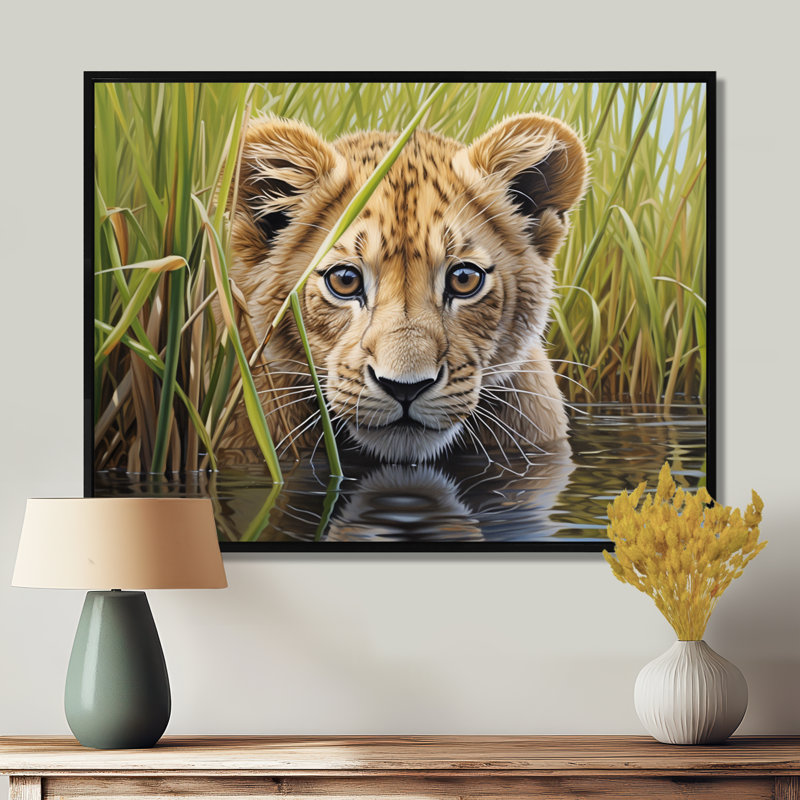 «Endearing Lion Cub By The River - Lion Animal», reproduction d'art murale, Toile flottante noire encadrée, H 12 po x l 20 po