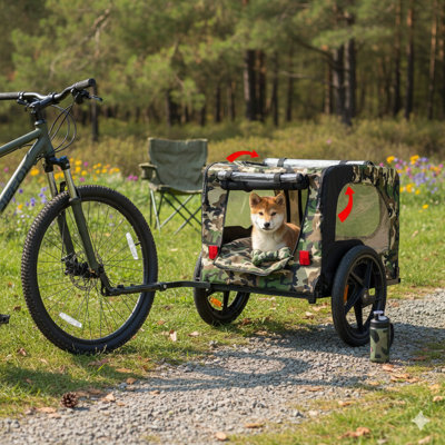 Le chariot de transport de vélos pour le transport de petits et moyens chiens, comprend un cadre qui se plie facilement, des roues à dégagement rapide, une surface de plancher antidérapante et une laisse intérieure intégrée