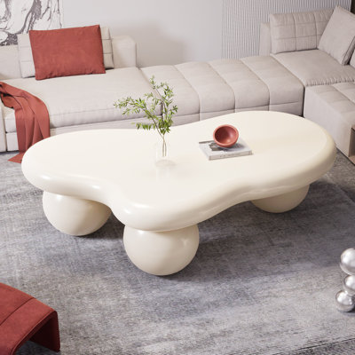 39.4" Modern Cloud Coffee Table – White Irregular Oval Top With Wood Ball Tripod Base, Soft Matte Finish by Wrought Studio