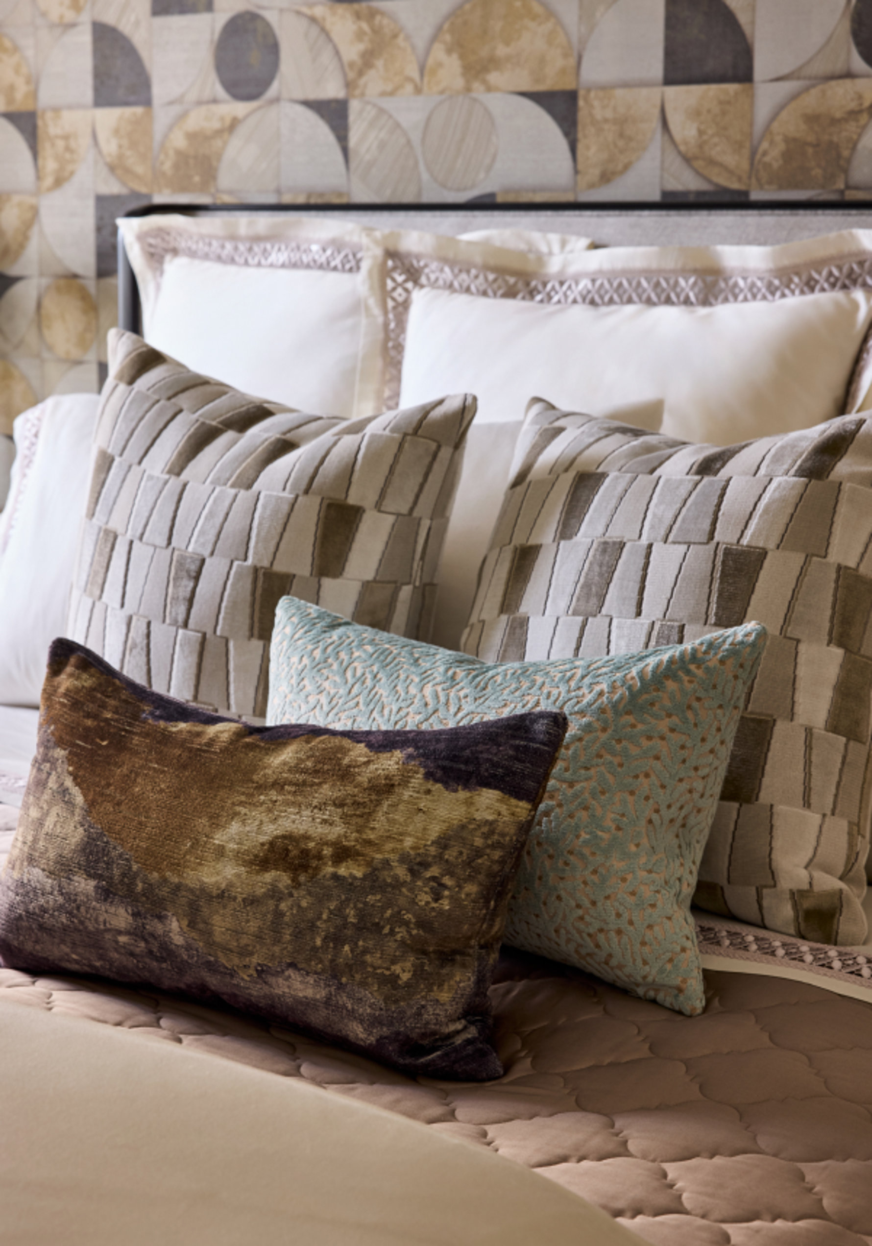 Various decorative pillows on a bed