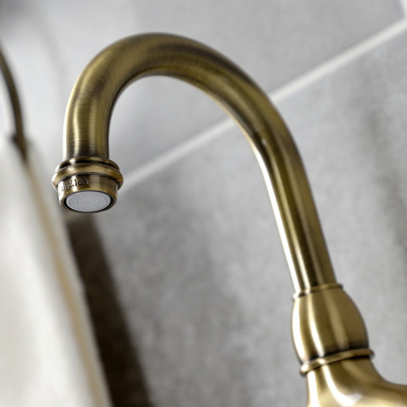 Kingston Brass French Country Two-Handle 3-Hole Deck Mount Bridge Bathroom Faucet with Brass Pop-Up, Antique Brass