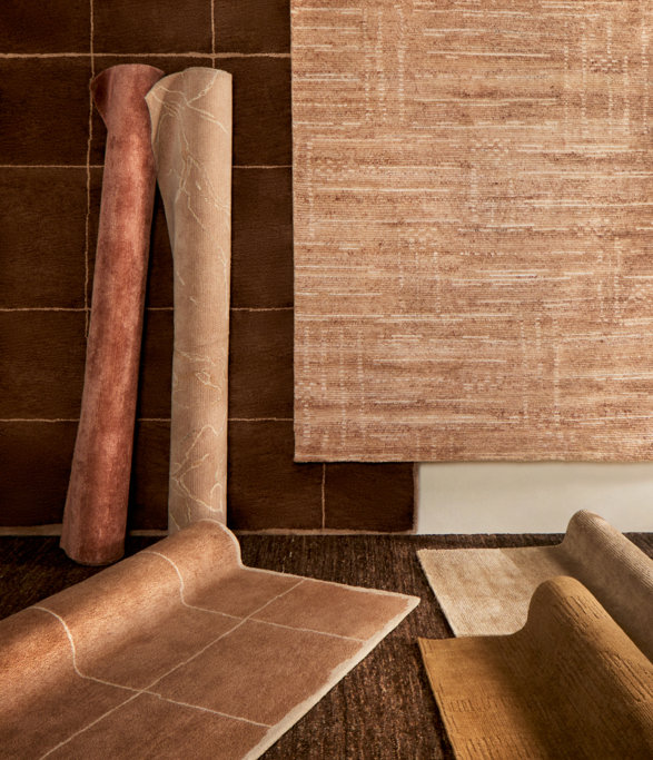 Several tan and brown rugs.