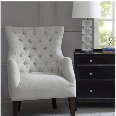Fauteuil à oreilles capitonné