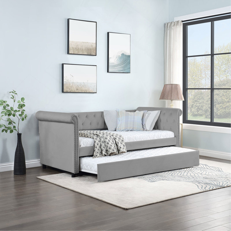 Lit de jour rembourré polyvalent avec lit gigogne et magnifique design de bras, idéal pour se détendre et accueillir des invités.