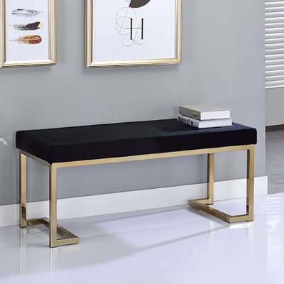 Banc de chambre à coucher moderne avec siège recouvert de tissu noir et métal champagne élégant pour une finition moelleuse