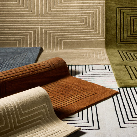 Assorted geometric patterned rugs in various colors.