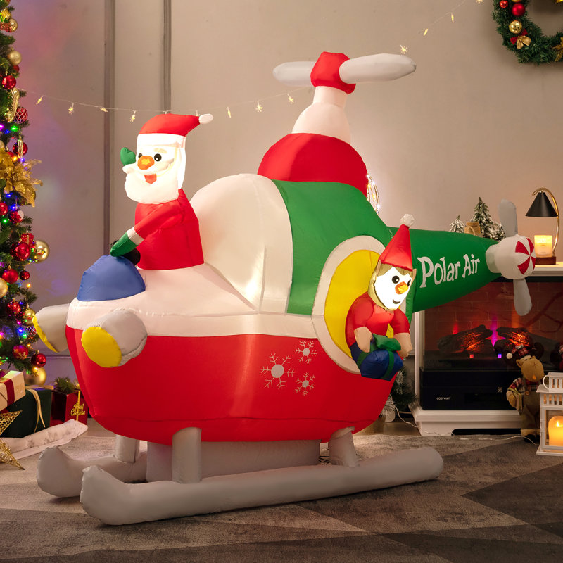 Grand père Noël volant d'un hélicoptère gonflable