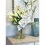 Orchids, Calla Lily And Philodendron Leaves Arranged In A Clear Circular Glass Vase