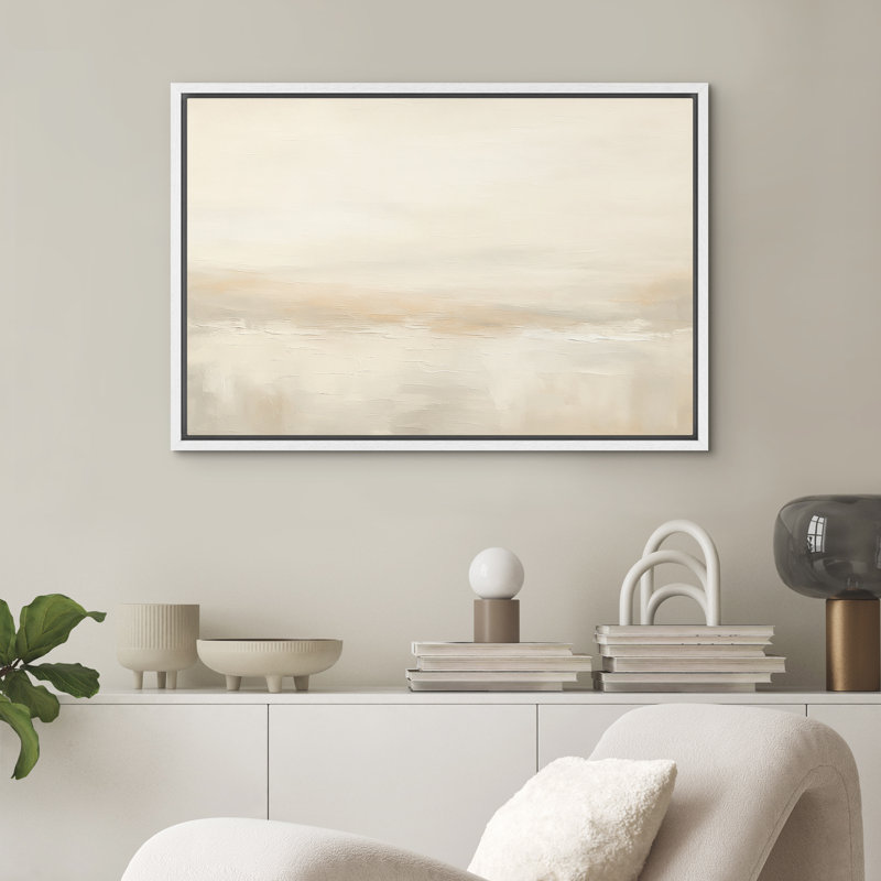 Rectangular framed abstract canvas wall art in a white floating frame with a beige landscape print.