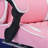 This Pink And White Racing-style Ergonomic Gaming Chair Features A Massage Lumbar Support, Footrest, And Adjustable Headrest For Comfortable Play.