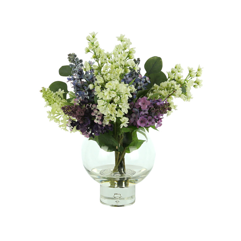 Lilac, Bouvardia And Eucalyptus Floral Arrangement In A Round Glass Vase