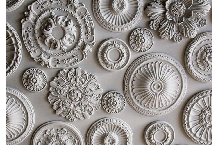 several white and ornate ceiling medallions clustered together
