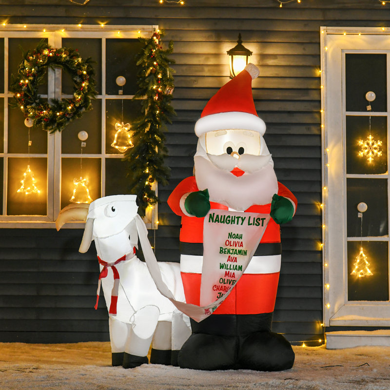 Père Noël de Noël avec chèvre gonflable