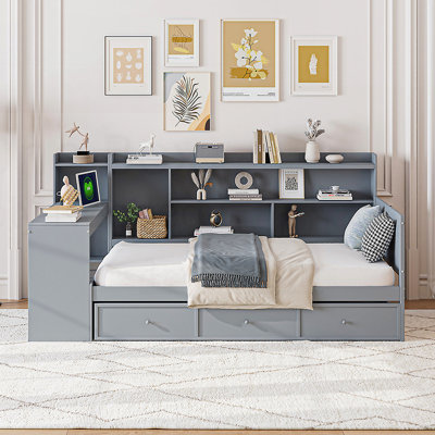 Structure de lit en pin durable avec tiroirs de rangement, compartiments latéraux et bureau intégré pour une utilisation optimale de l'espace