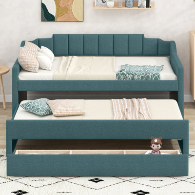 Lit de jour simple avec tiroirs et lit gigogne pour une chambre d'amis pratique avec rangement tapissier
