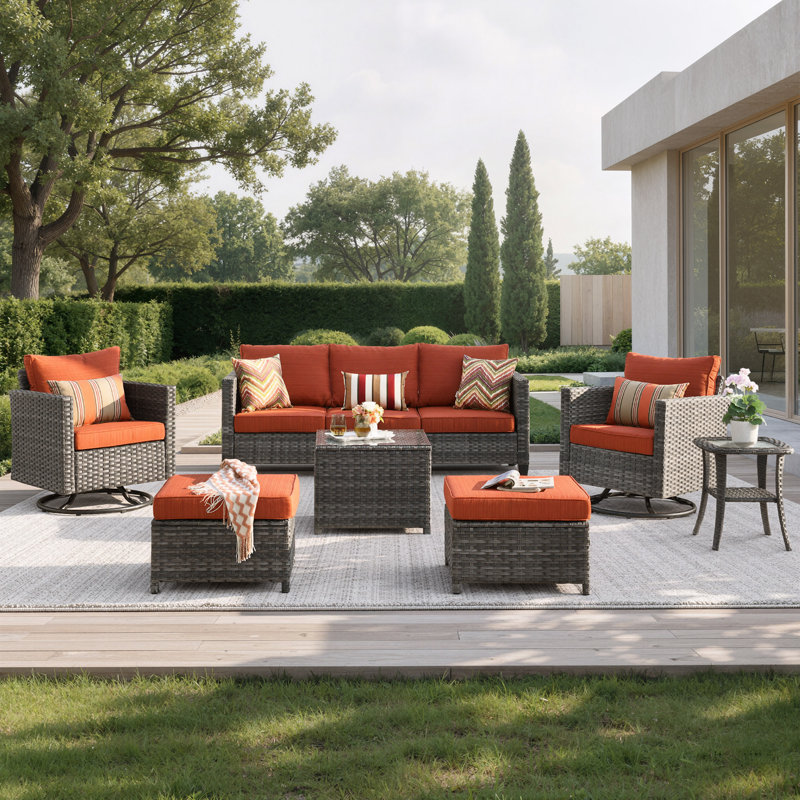 7-Piece Outdoor Wicker Patio Conversation Set with Swivel Rocking Chairs, Ottomans, Cushions & Glass Coffee Table, Orange Red