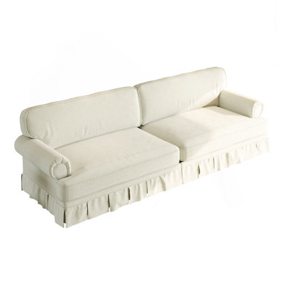 Canapé 4 places luxueusement confortable avec siège très profond, accoudoirs roulés et jupe plissée pour les espaces de vie modernes.