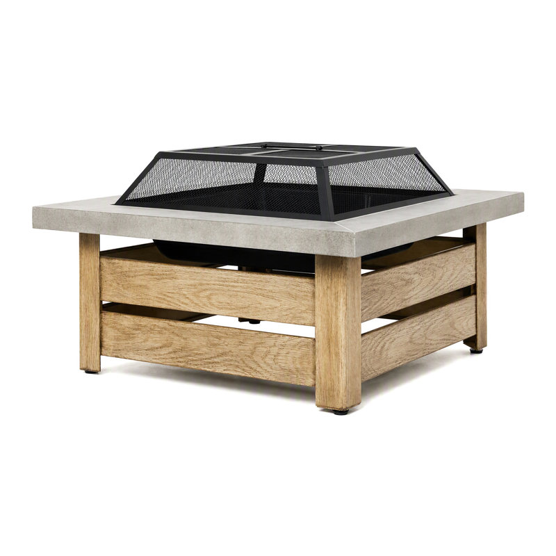 Foyer extérieur en acier de 86 cm (34 pouces) à bois, avec table et motif décoratif ajouré, idéal pour les feux de camp dans le jardin ou la terrasse.