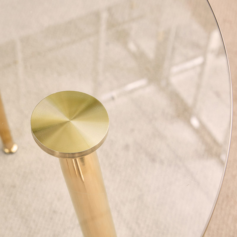 table ronde ronde en verre trempé transparent avec pieds en métal doré, jumelée à 4 chaises de salle à manger à haut dossier en polyuréthane