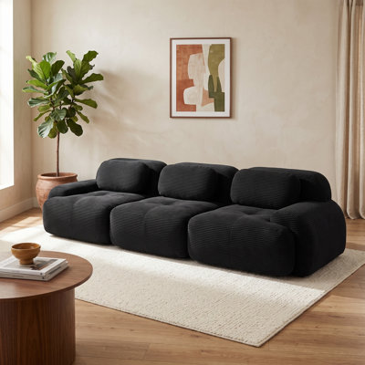 Canapé modulaire 3 places en velours côtelé noir, profil bas, avec coussins moelleux et accoudoirs incurvés